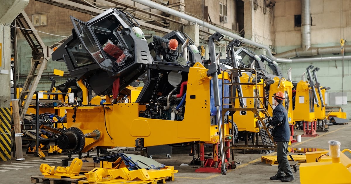 Male workers of industrial plant checking equipment