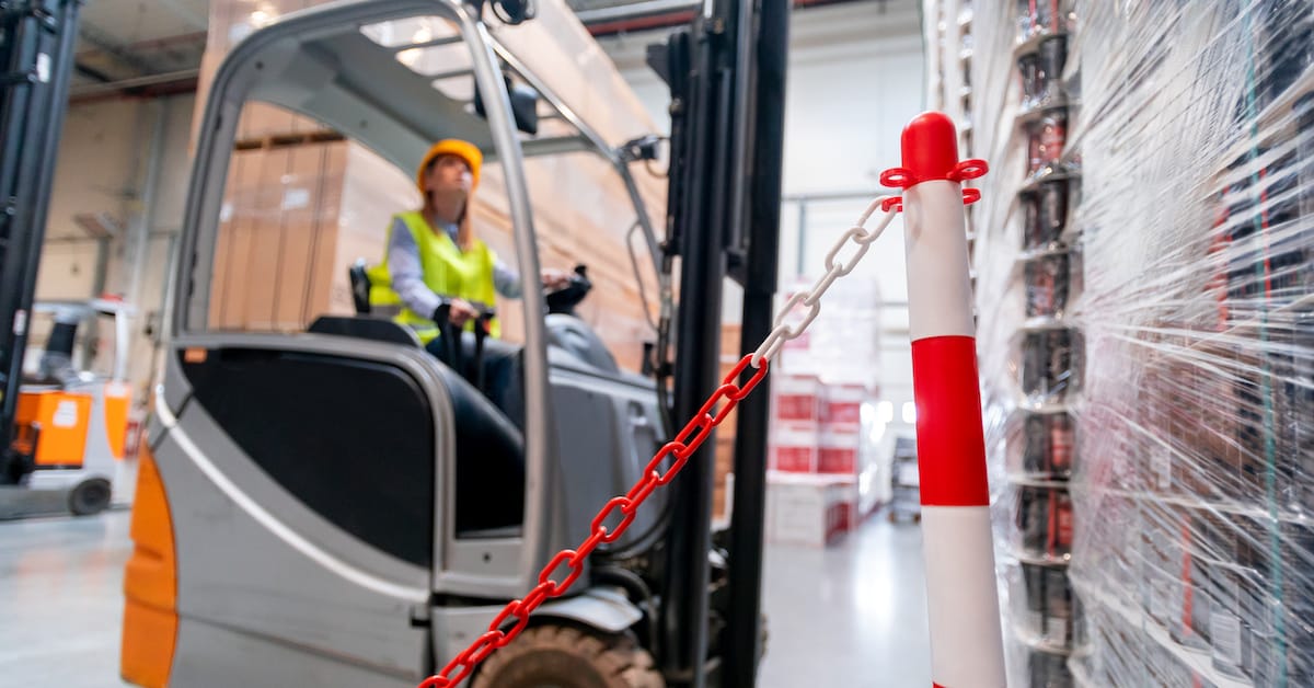 Safety at work with forklift in warehouse