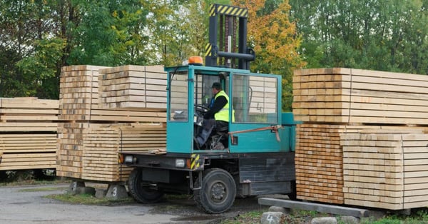 Forklift transports boards at a plant
