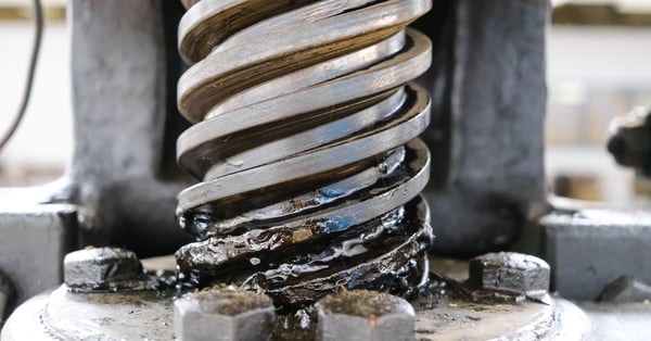 Industrial manual spindle press detail showing grease lubrication