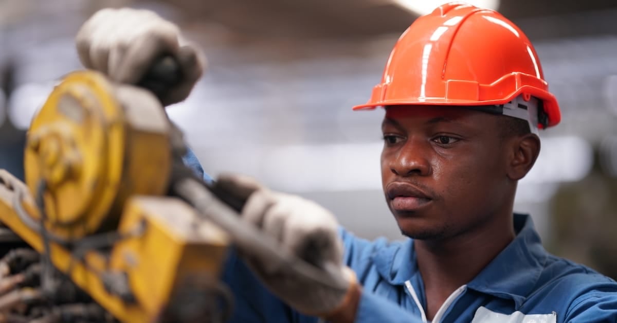 Industrial factory employee working in metal manufacturing