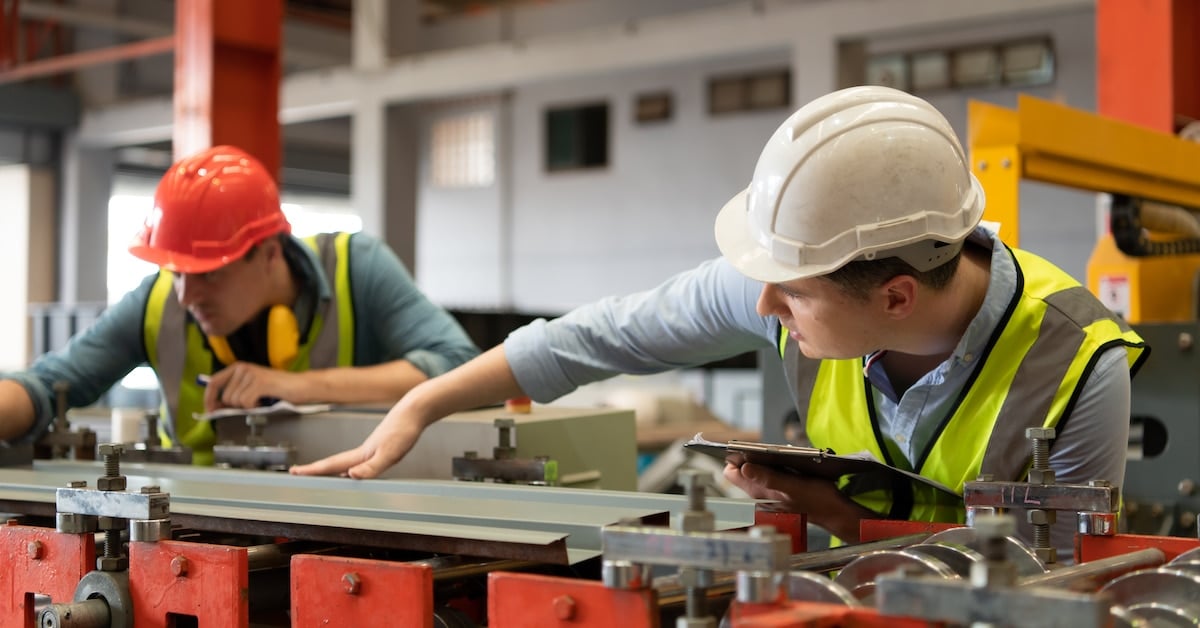 Two young engineers testing and verifying the operation of equipment