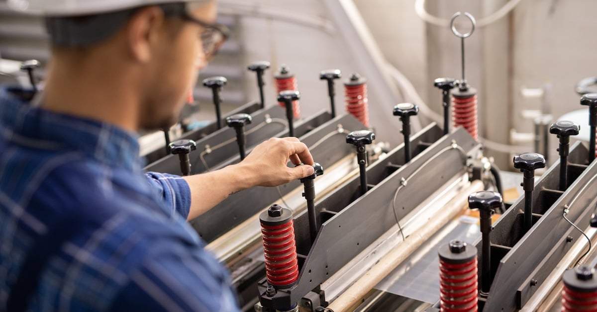 Industrial equipment being operated by a young professional