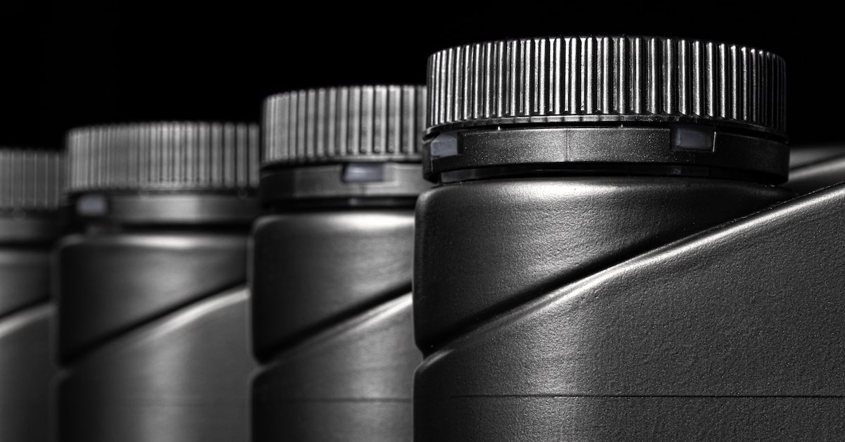 Engine oil bottle on black background close up