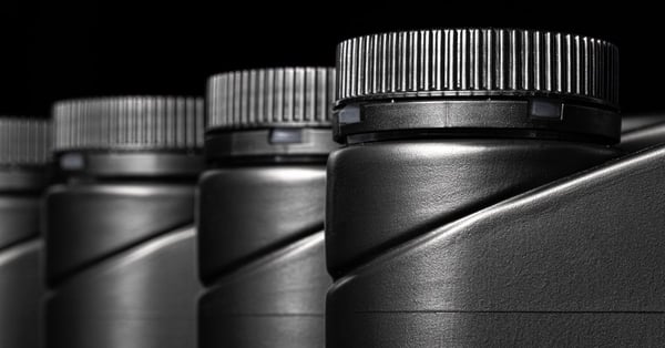 Engine oil bottle on black background close up