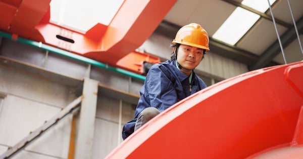 Worker in crane manufacturing facility