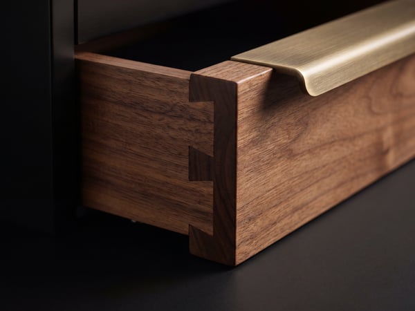 Close-up of handcrafted joinery detail with brass hardware
