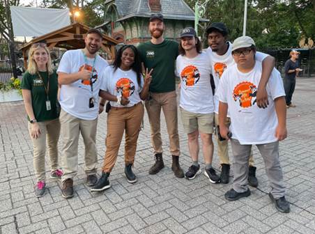 A group of Philadelphia Zoo staff pose for a photo near the main gate.