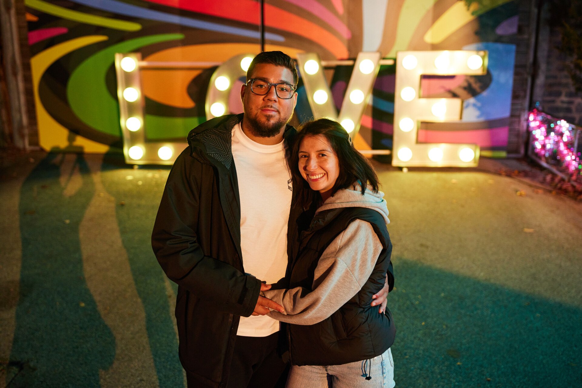 A couple poses in Winter of Love at Philadelpia Zoo's LumiNature holiday light show.