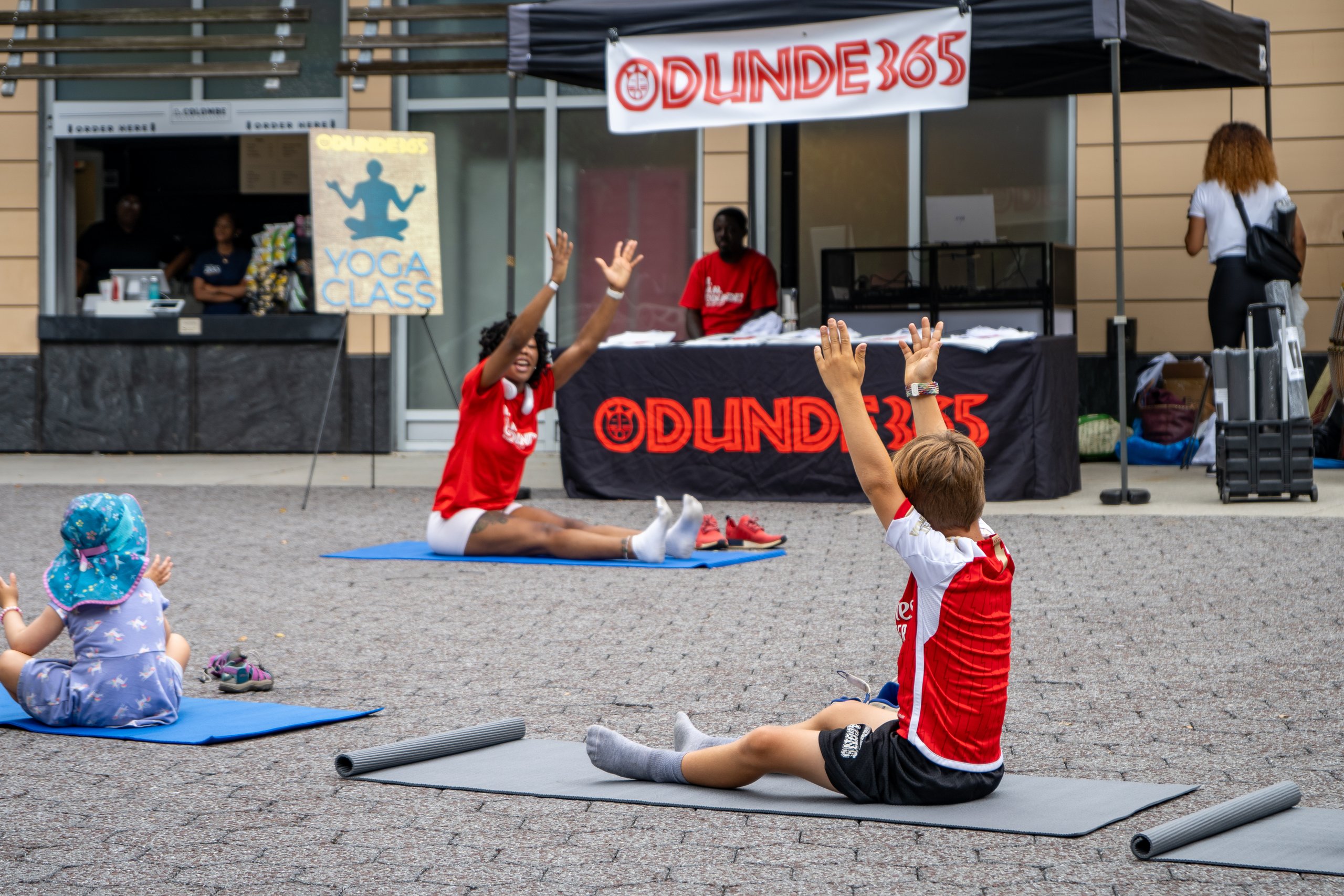 Guests participate in a guided yoga session during African Culture Fest at Philadelphia Zoo.
