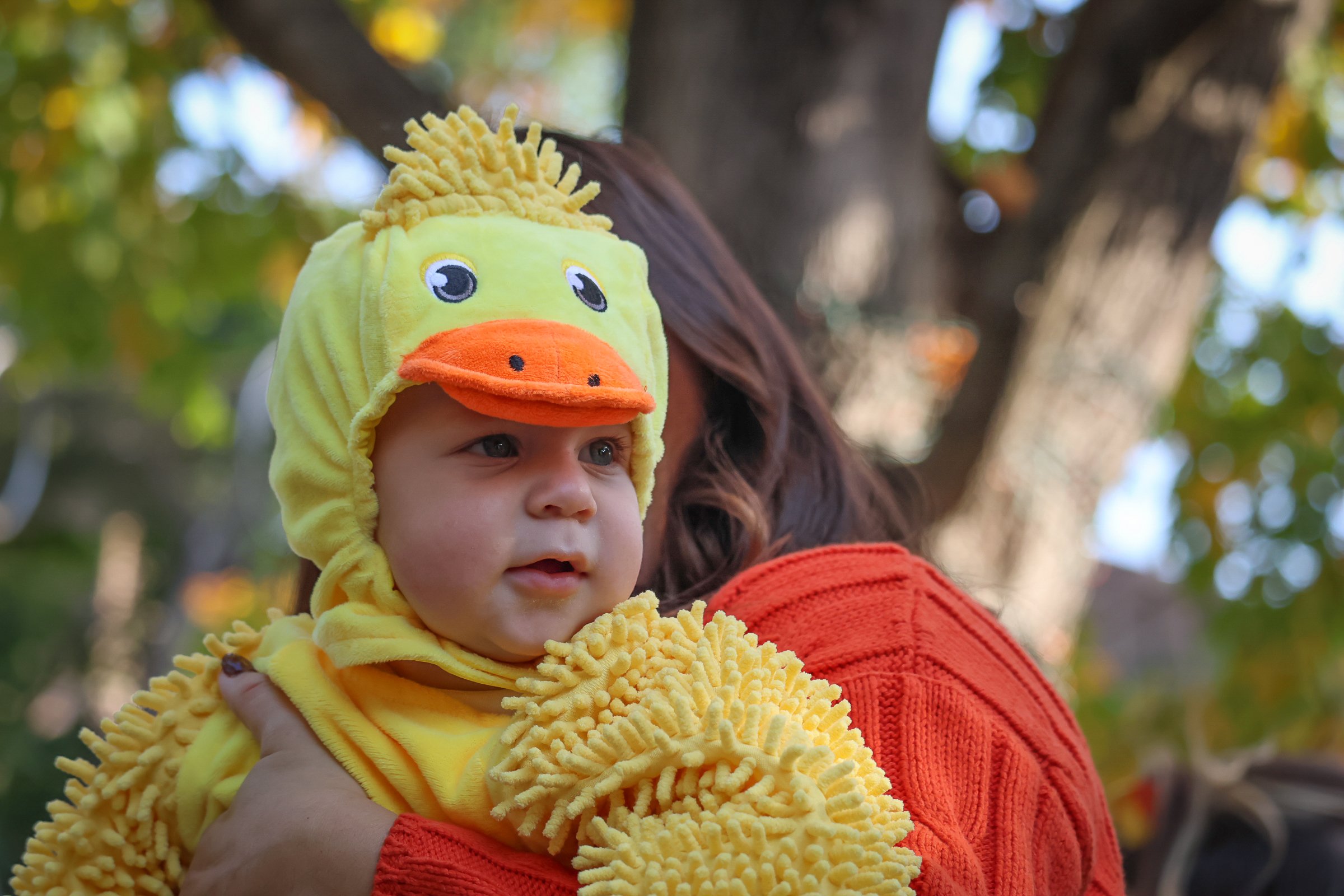 A small child in a duck costume poses for a photo during Boo at the Zoo at Philadelphia Zoo.