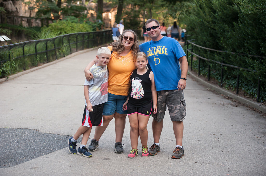 A family poses for a photo on the path during a members-only event at Philadelphia Zoo.
