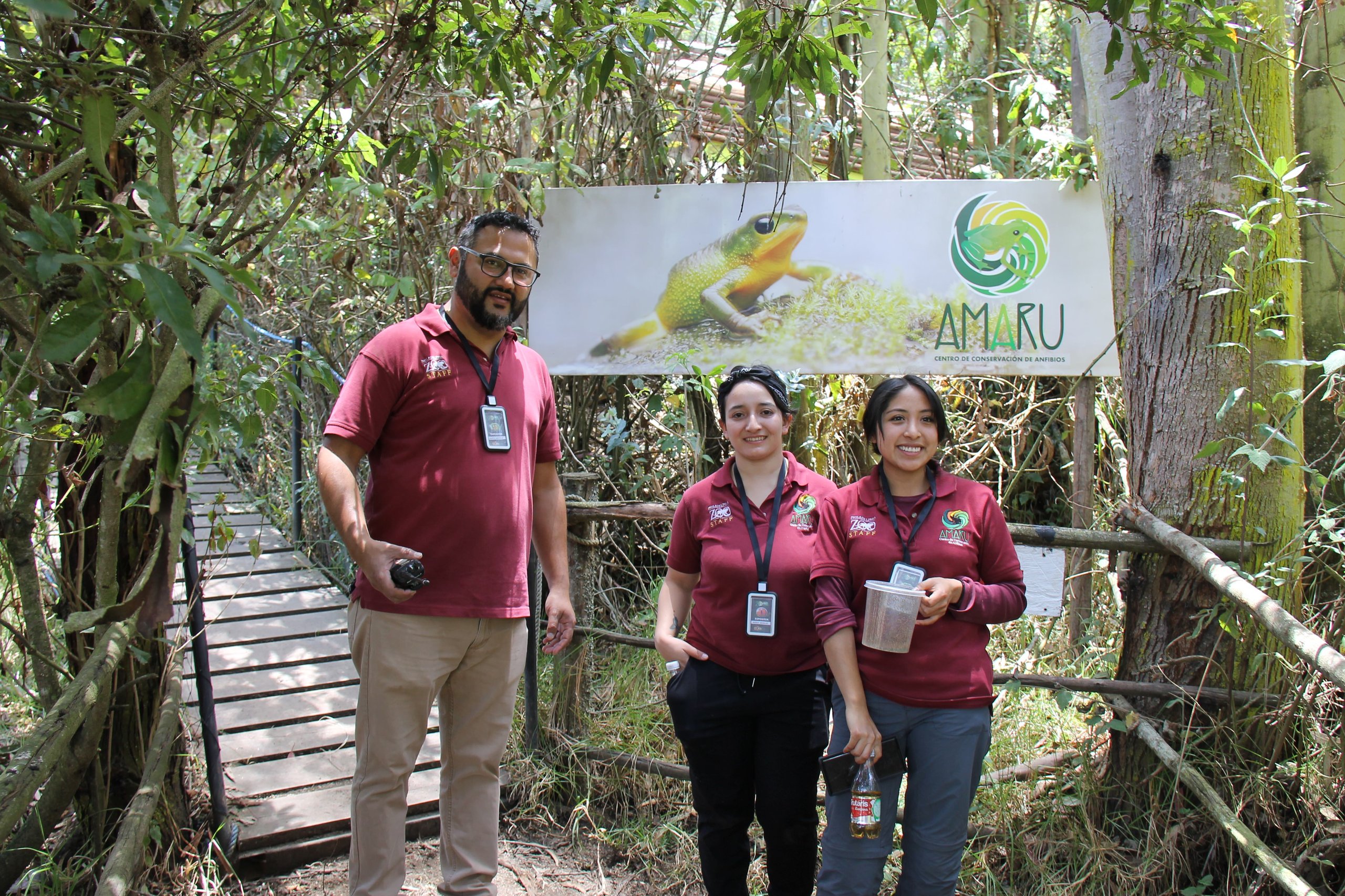 Staff members of Zoo Amaru, a conservation partner of Philadelphia Zoo, stand in front of their branded banner.