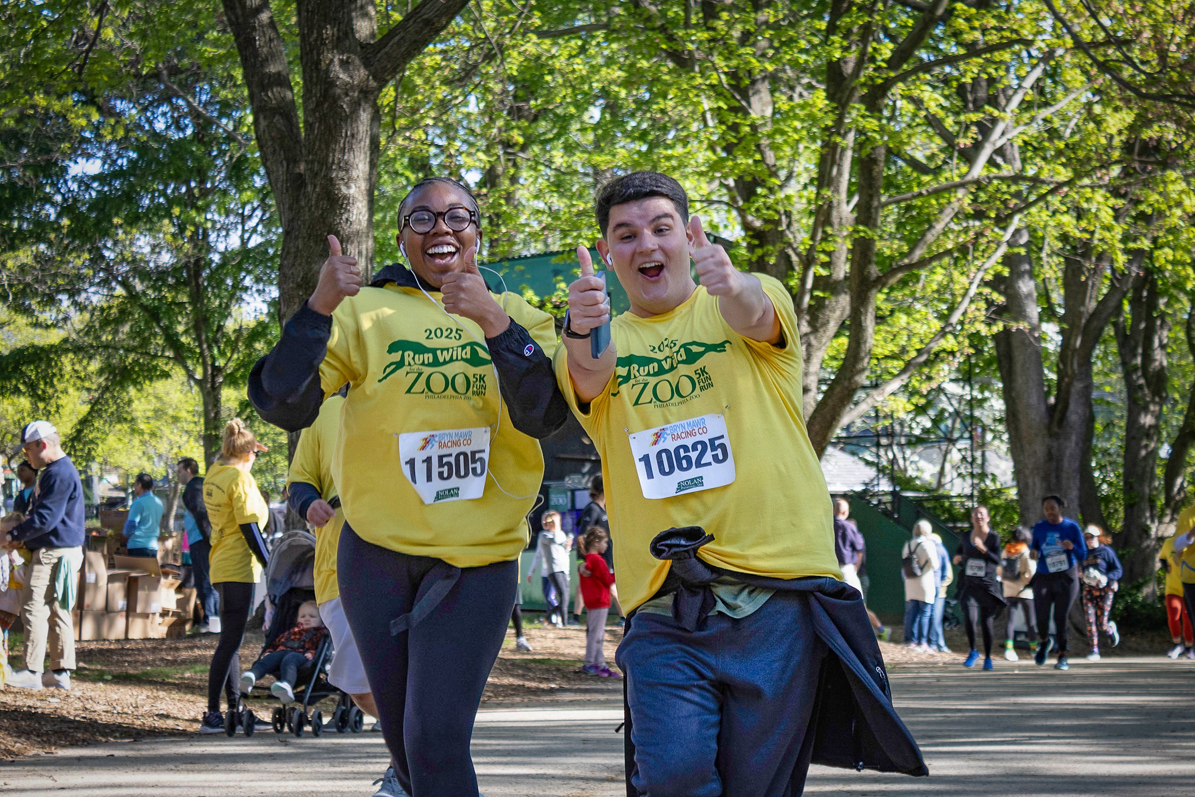 Two runners pose for a photo while running in the Run Wild 5K at Philadelphia Zoo.