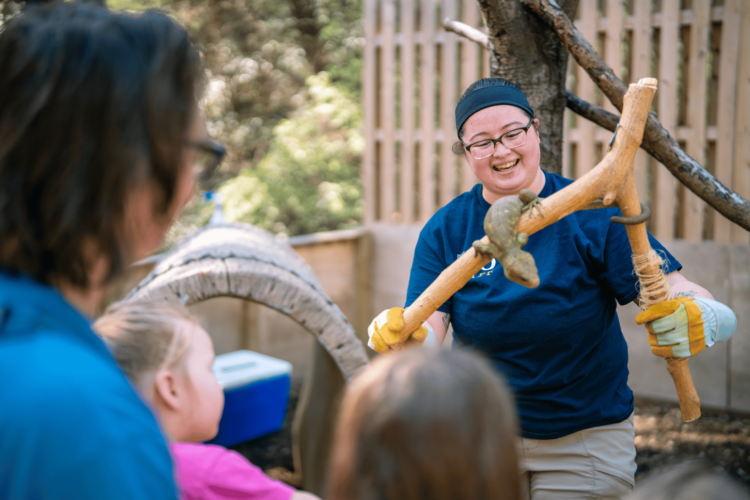 An animal care specialist shows a skink, one of the Zoo's ambassador animals, to guests at a Discovery Zone at Philadelphia Zoo.