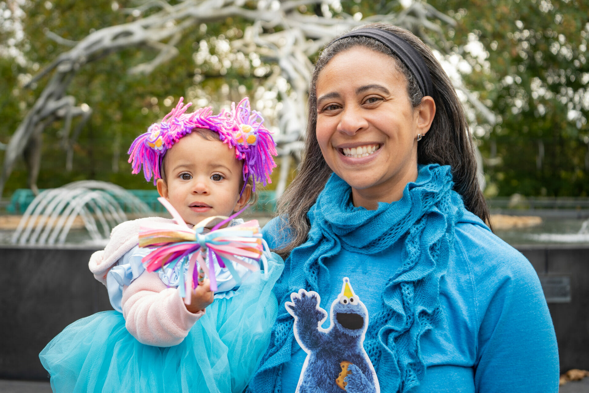 A mother and her child dressed up as Cookie Monster and a princess pose for a photo during Boo at the Zoo at Philadelphia Zoo.