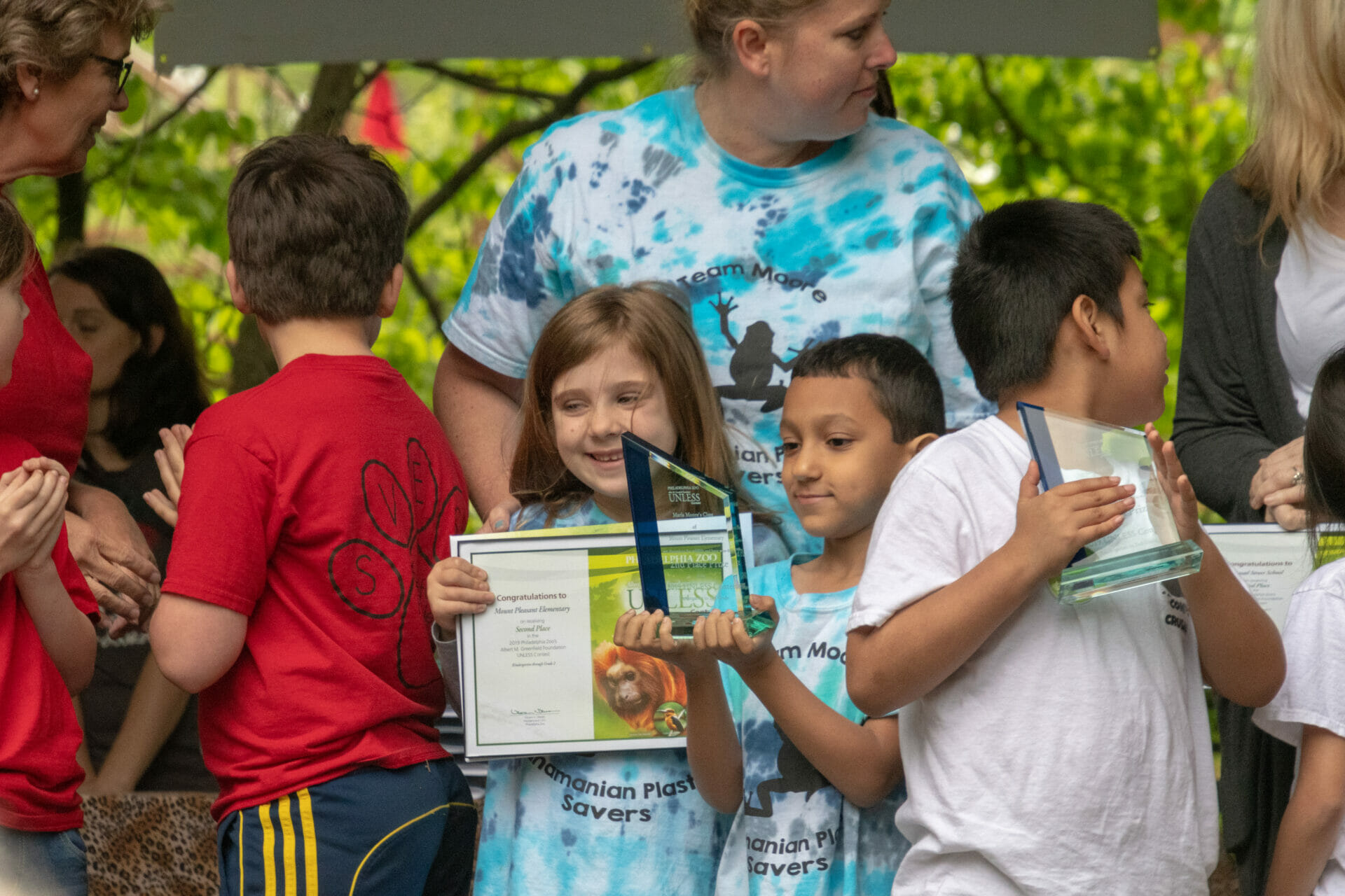 Student holding up award and smiling at Awards Ceremony Mount Pleasant Elementary School K 2 2019