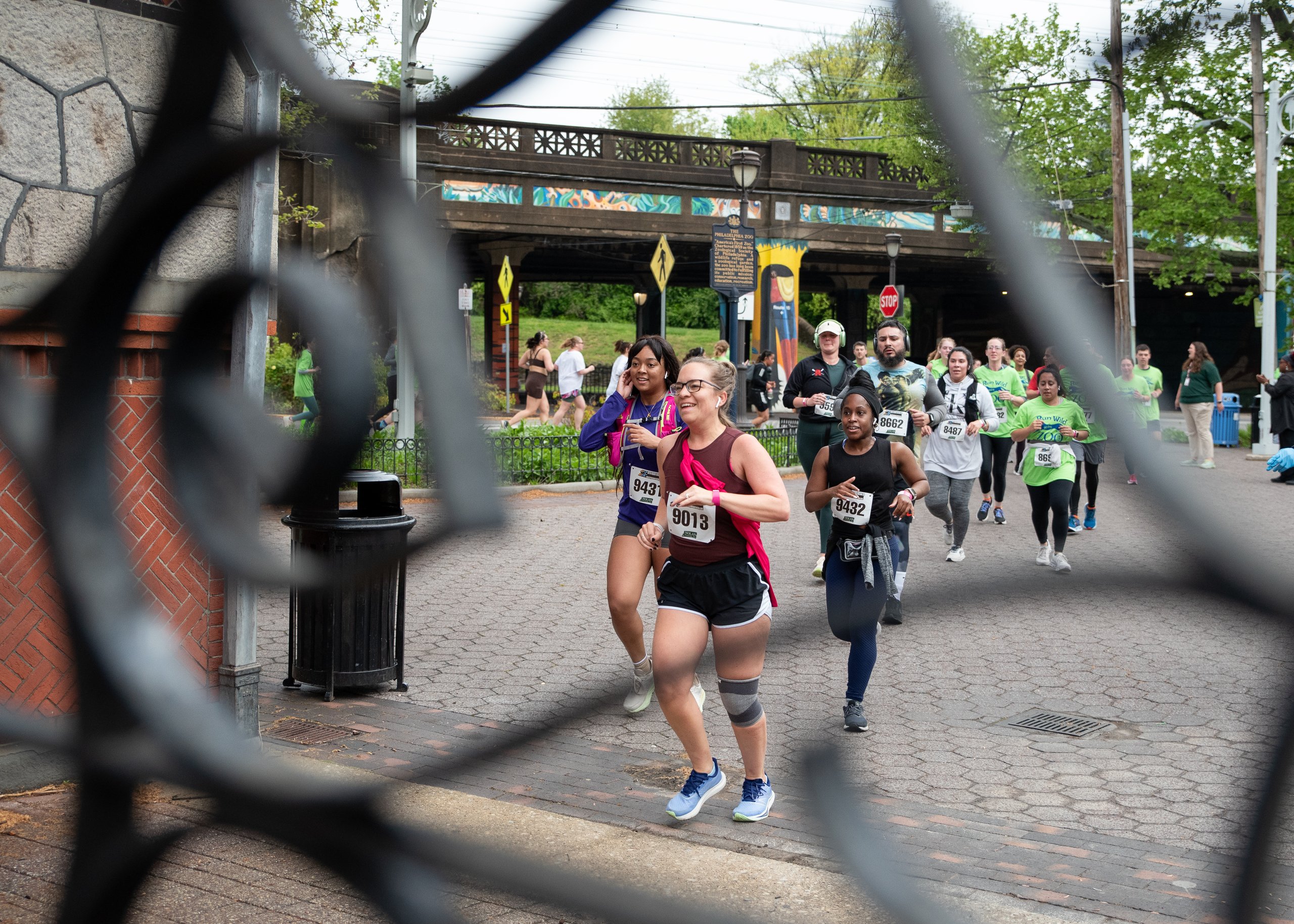 A group of runners approach the Philadelphia Zoo's main gate during the Run Wild 5K and Fun Run event.