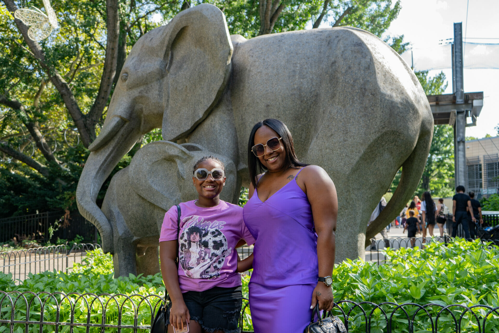 Two Philadelphia Zoo members stand in front of the iconic elephant statue located near the front gate.