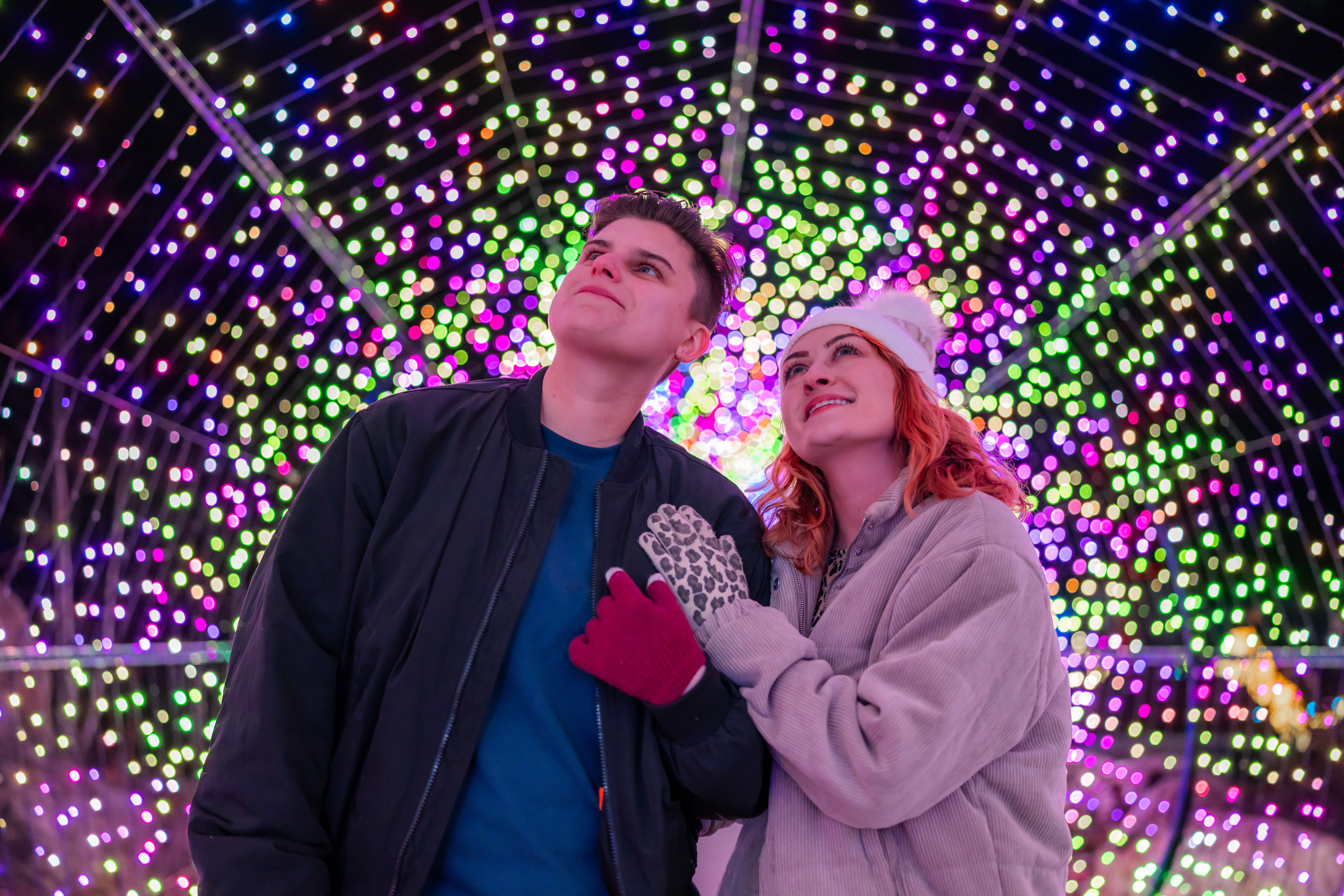 A couple walks through the light tunnel at LumiNature, Philadelphia Zoo's holiday light show.