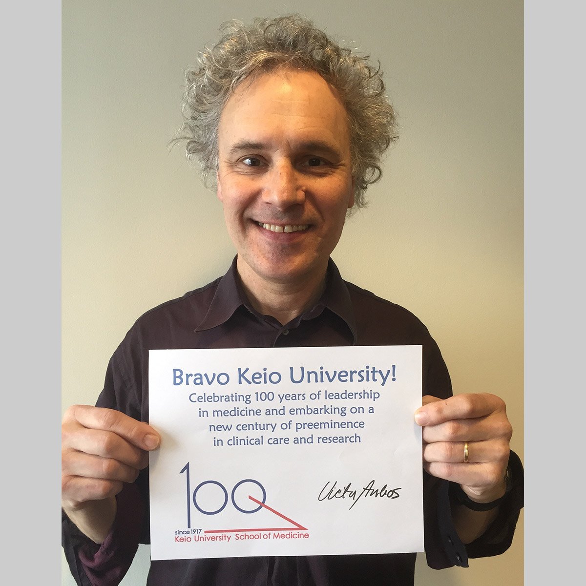 Victor R. Ambros holding a message