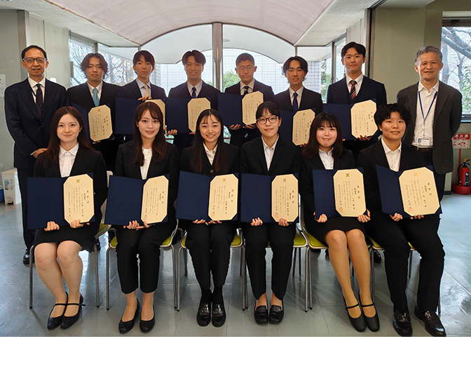 Group photo of students holding their award certificates
