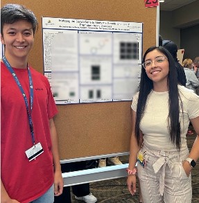 Photo of people standing in front of presentation materials