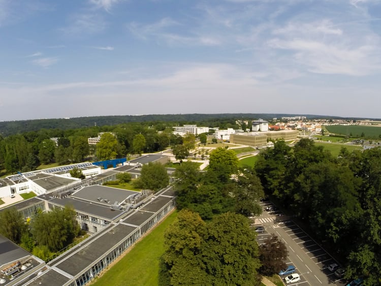 An aerial view of the campus. A photo showing the lush natural environment of the surrounding area.