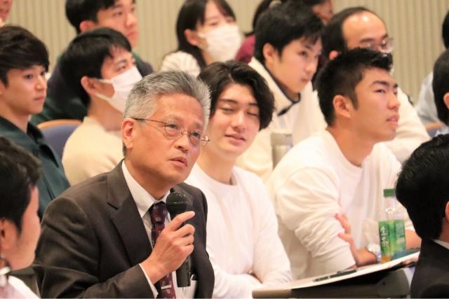 Dean Misawa of the Graduate School of Pharmaceutical Sciences answering a question during the discussion