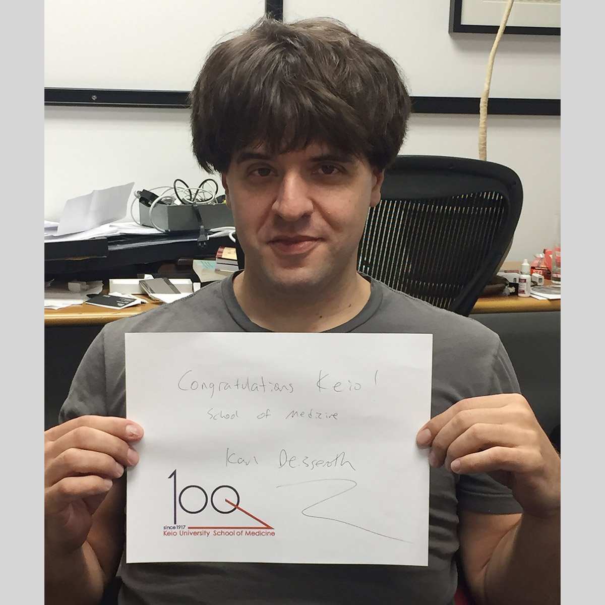 Karl Deisseroth holding a message