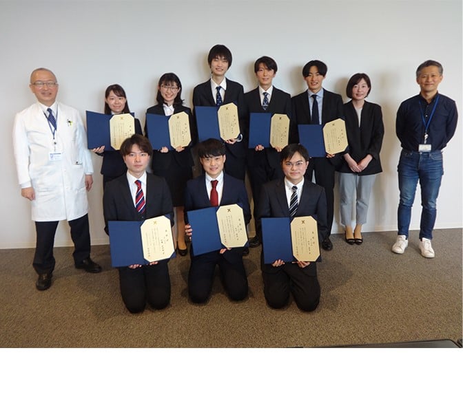 Group photo holding award certificates
