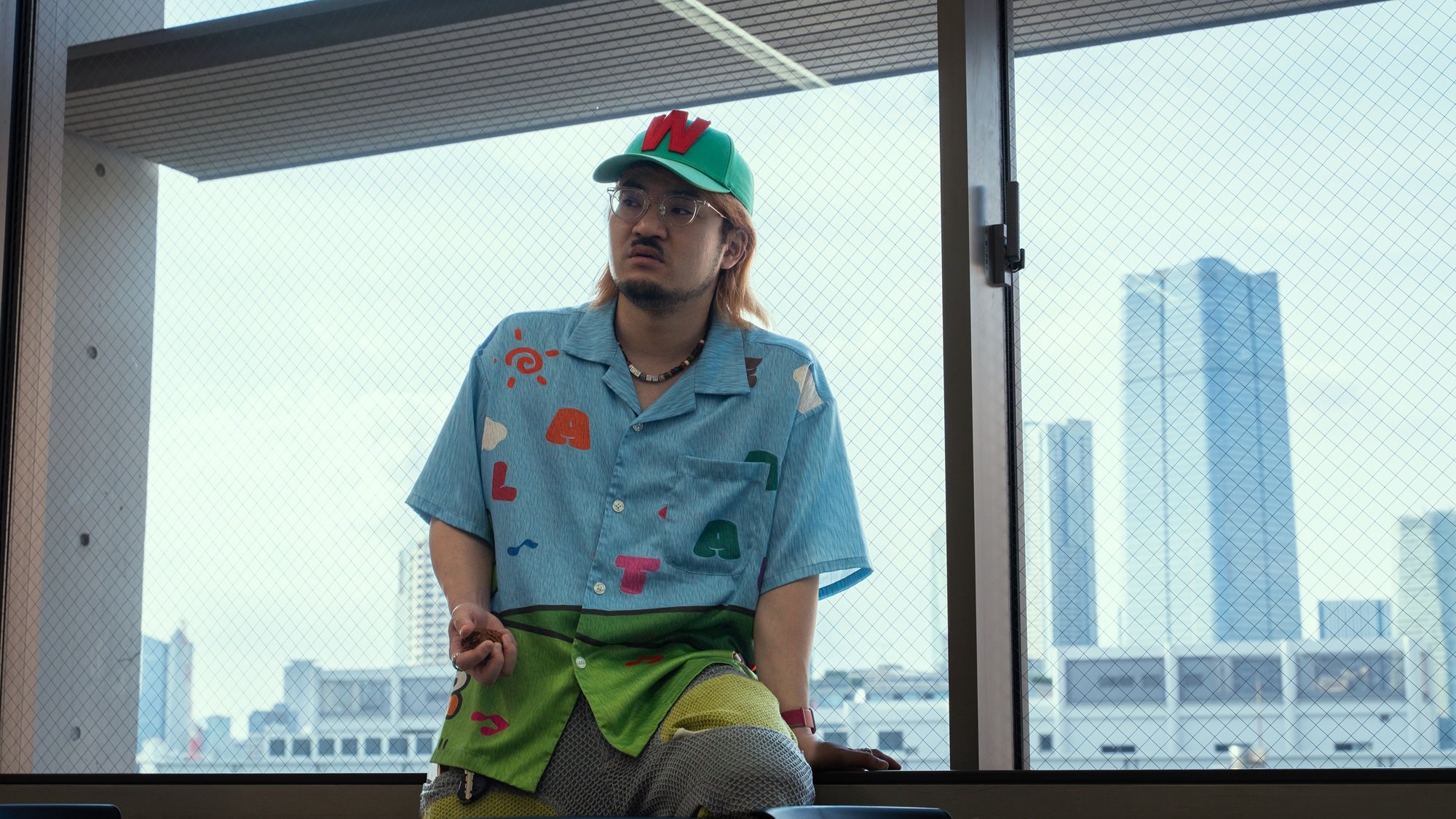 窓に腰掛ける岩崎監督。