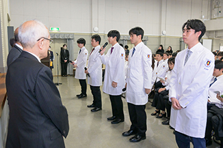 Image of students lined up in white coats
