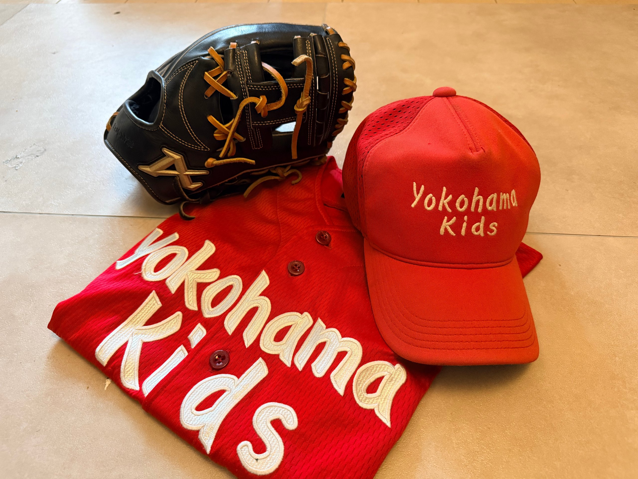 The eldest son's youth baseball gear and game uniform
