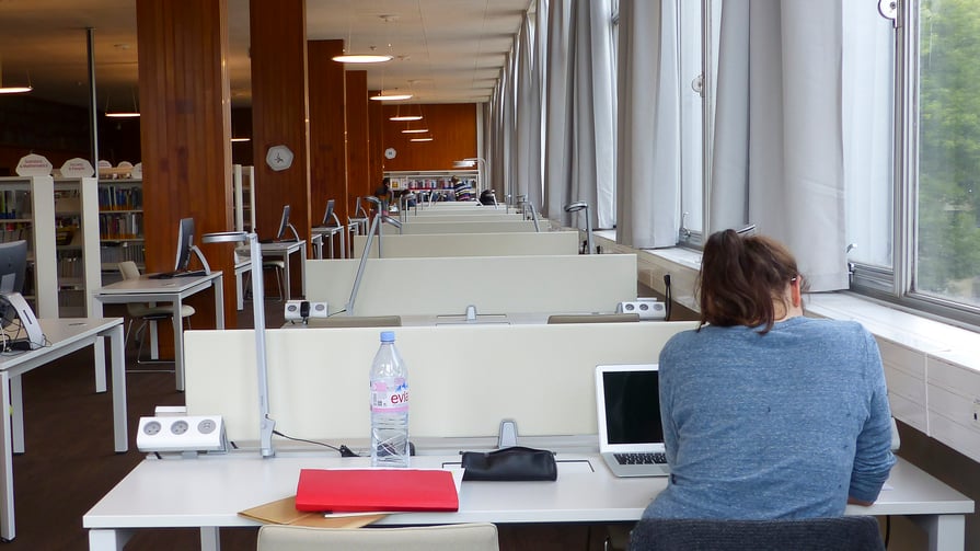 A photo of a student at a desk in a study space.