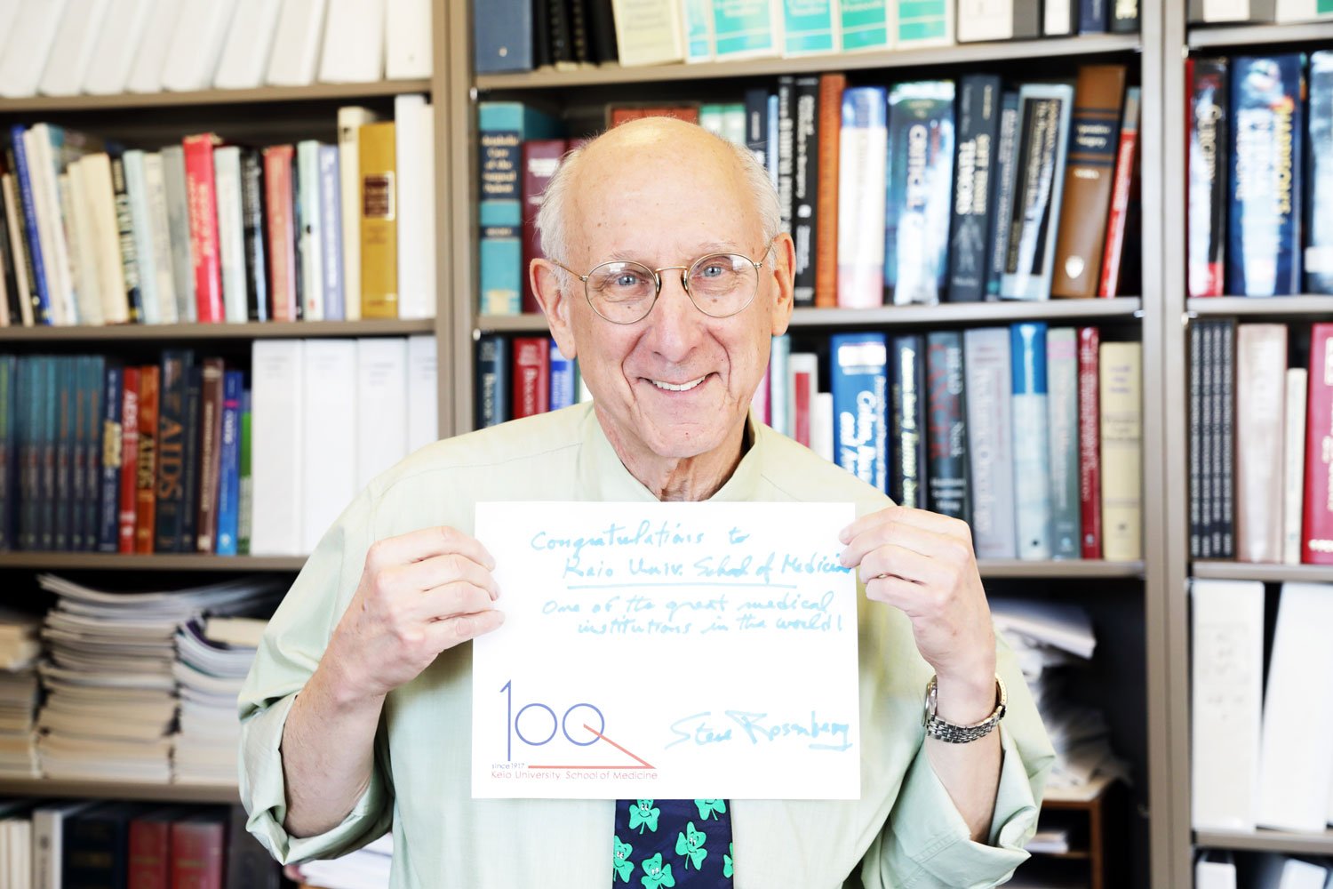 Steven A. Rosenberg holding a message