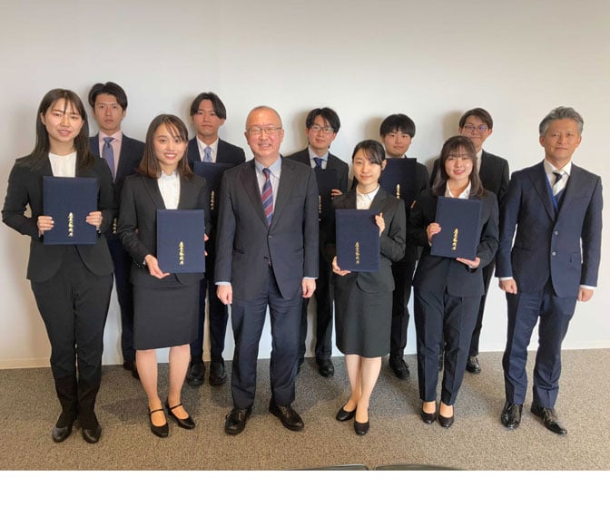 Group photo holding award certificates