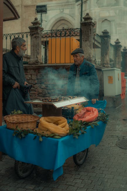 Elderly men selling roasted chestnuts at a food stand in Bursa, Turkey.