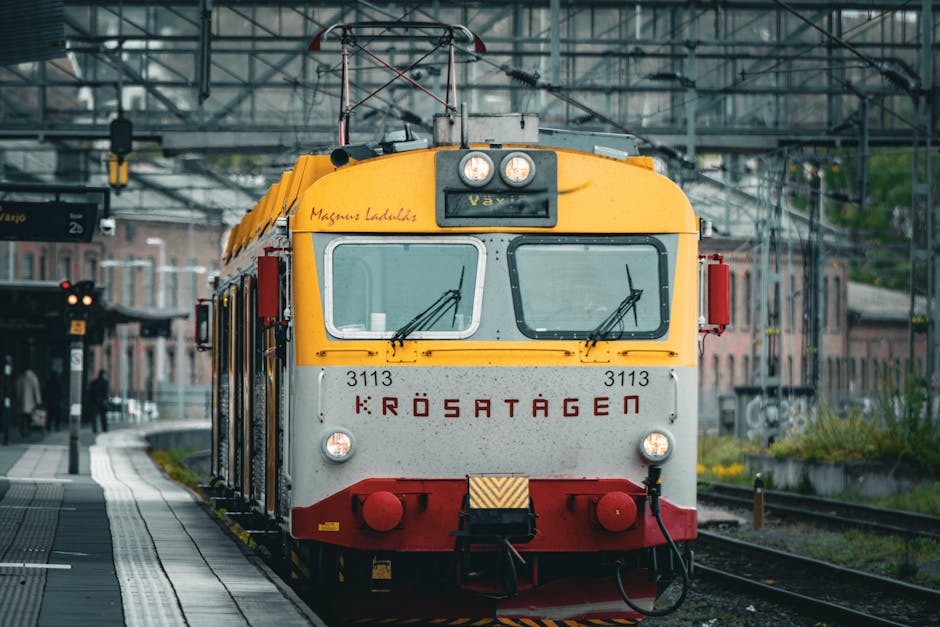 Electric yellow and red train arrives at Jönköping Central Station, Sweden.