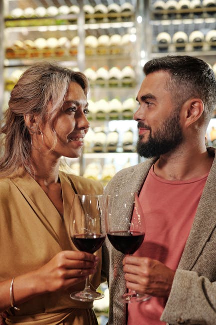 Couple enjoying a romantic moment with wine in a cozy indoor setting, ideal for lifestyle and relationship themes.
