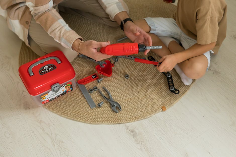 A father and son bonding over a toy tool set indoors, fostering creativity and learning.