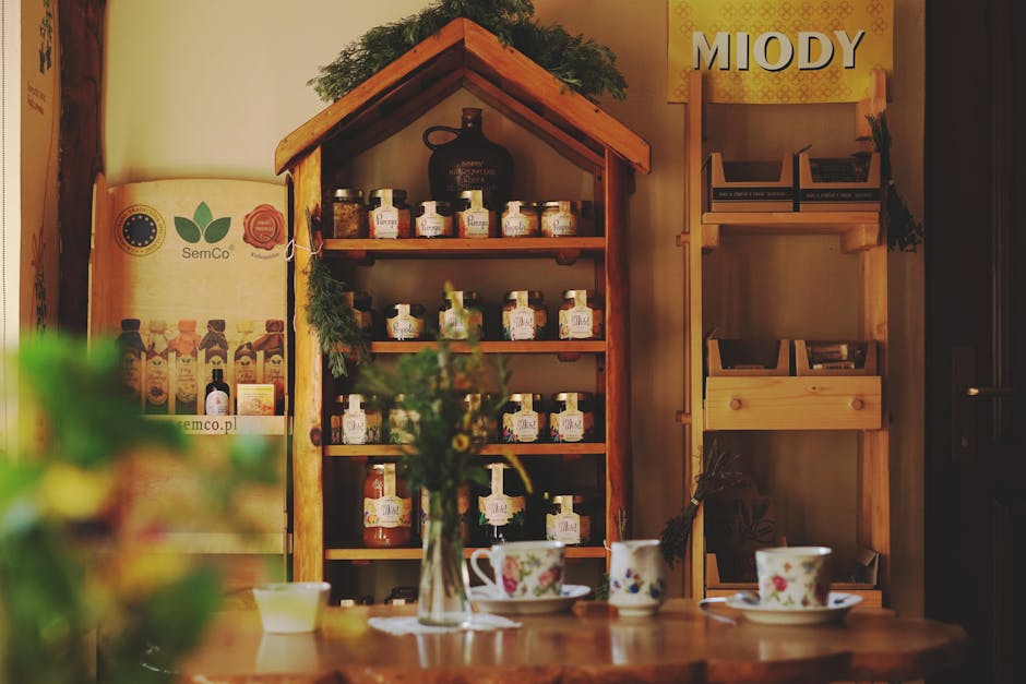 Charming café interior with shelves of honey jars, cups on a wooden table.