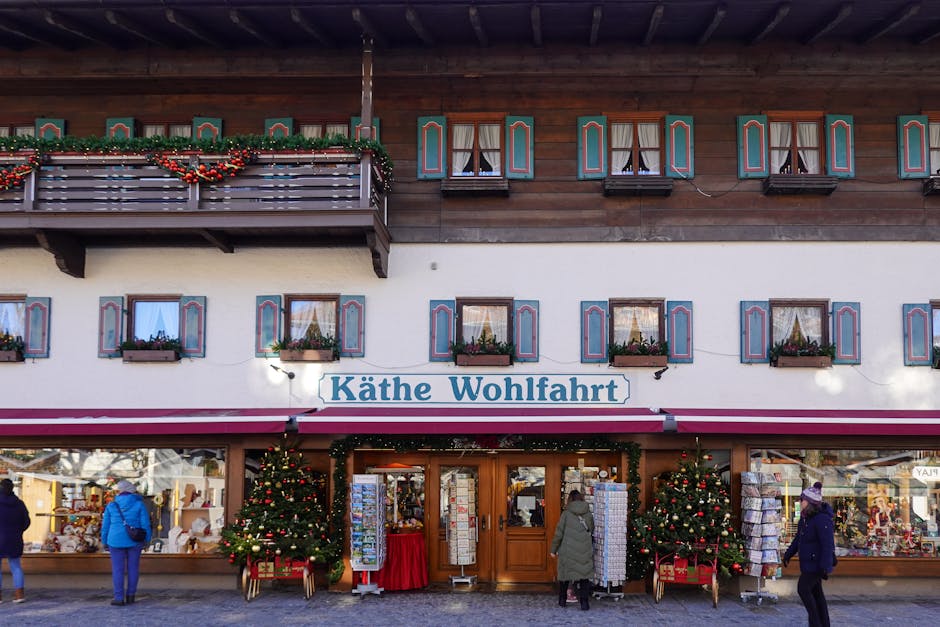 A charming alpine village store decorated for Christmas with festive ornaments and trees.