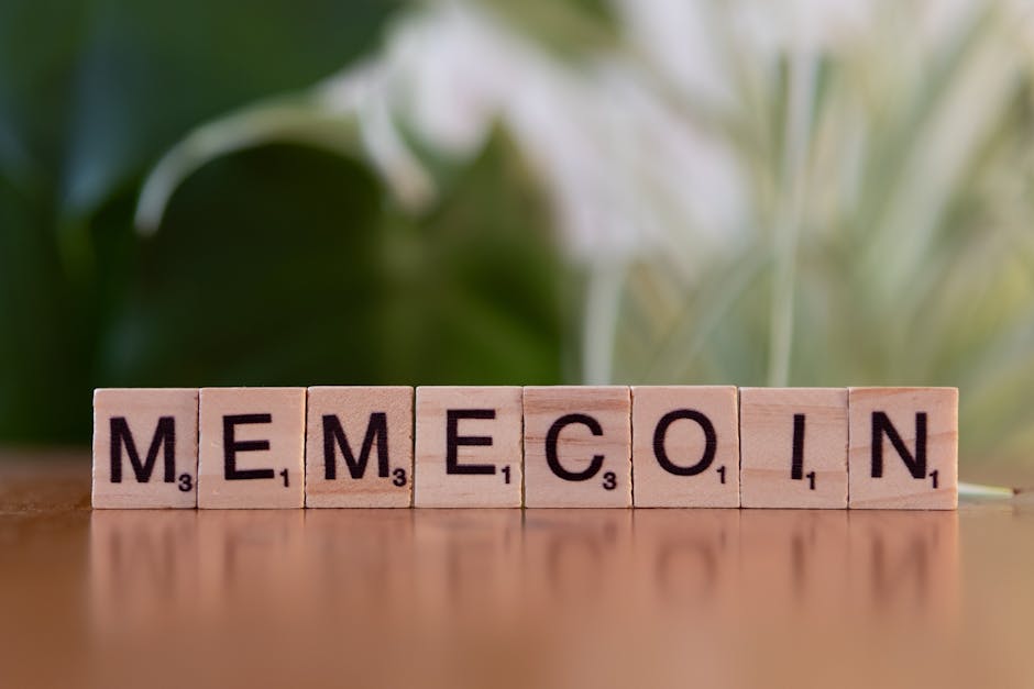 Wooden tiles spelling 'Memecoin' on a blurred background.
