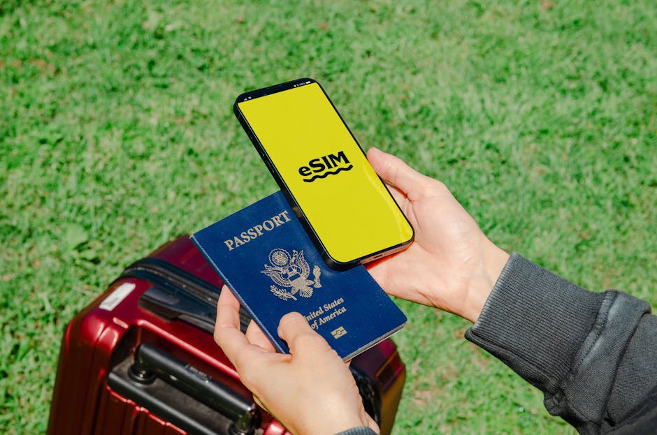 Hands holding a smartphone with eSIM and a passport near a luggage outdoors, ideal for travel concepts.