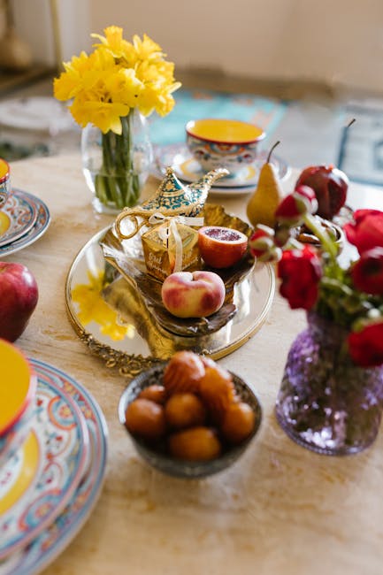 Colorful Eid table with fruits, traditional dishes, and vibrant flowers, beautifully arranged for a festive celebration.