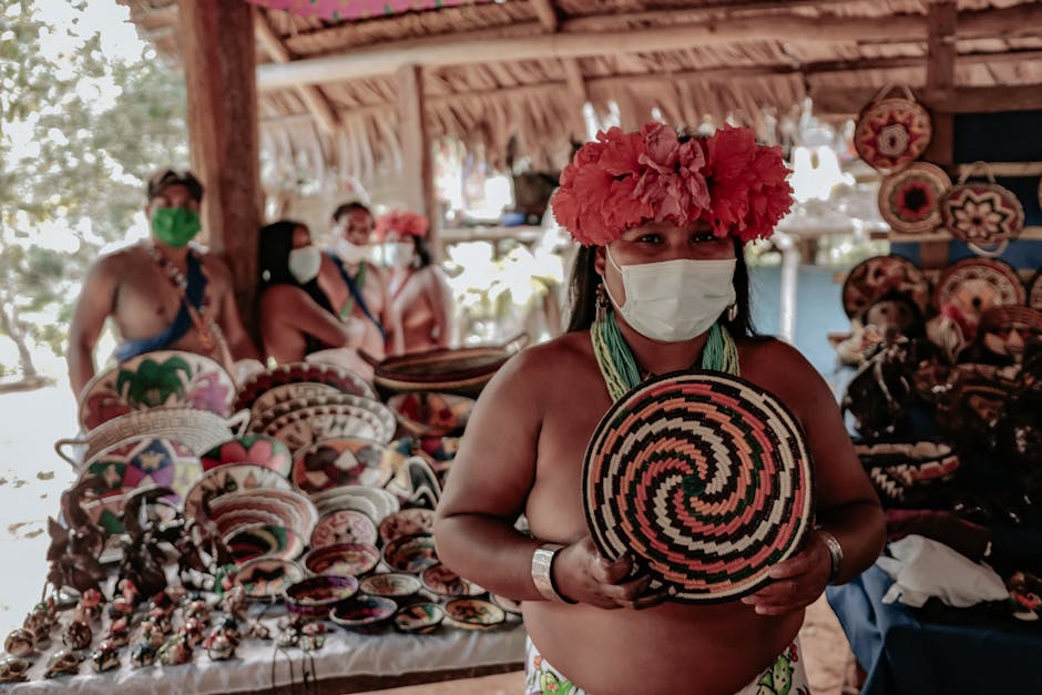 Indigenous artisan at market with colorful woven basket and pottery. Cultural display.