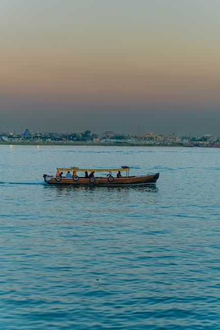 Peaceful dusk scene of a traditional boat on Shatt al-Arab River in Basrah, Iraq, capturing the tranquil water.