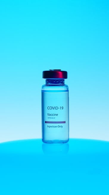 A COVID-19 vaccine vial with a blue background, symbolizing medical advancement.