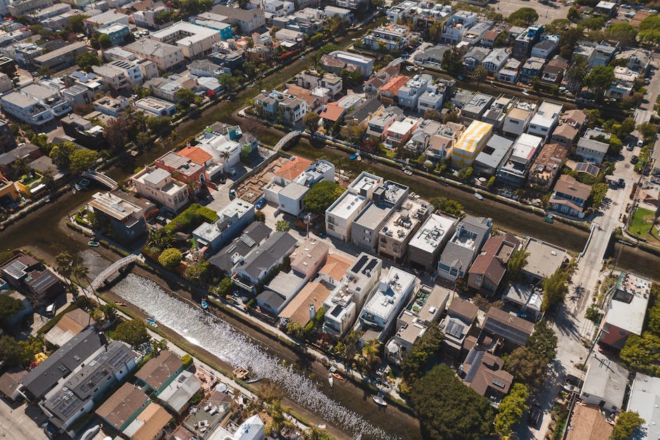 A scenic aerial shot showcasing a residential neighborhood with a canal running through it.